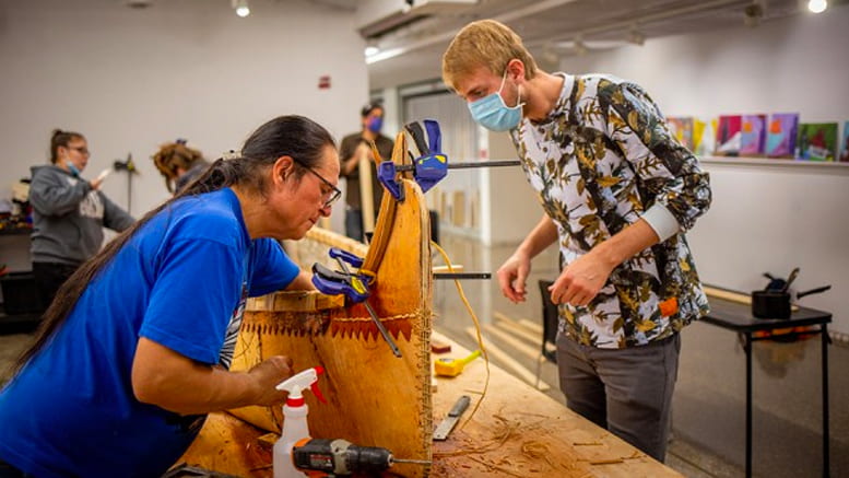 Wayne Valliere and student build a canoe