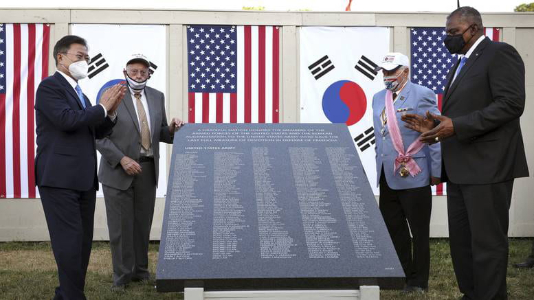 Then-South Korean President Moon Jae-in, left, and U.S. Secretary of Defense Lloyd Austin unveil a replica section of the Wall of Remembrance at the Korean War Veterans Memorial during its groundbreaking on May 21, 2021 in Washington. (Kevin Dietsch/Getty)