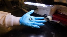 Hand holding a prototype all-perovskite tandem solar cell